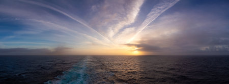 Dramatic Colorful Sunrise Sky over North Atlantic Ocean. Cloudscape Nature Background. Panoramaの写真素材