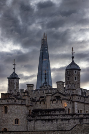 Historic Brick Building, Tower of London, in a modern city during dramatic sunset. London, United Kingdom. Travel Destinationの写真素材