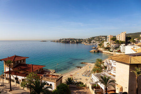 Sandy Beach, Colorful Blue Sea Water and Residential Homes on Mediterranean Coast. Palma, Balearic...