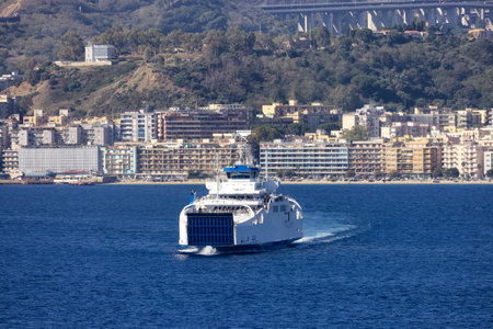 Ferry Boat with Downtown City by the Sea in background. Messina, Sicilia, Italy. Sunny Morning.の写真素材