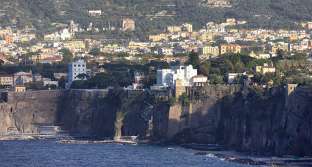 Rocky Coast and Homes in Touristic Town, Sorrento, Italy. Amalfi Coast. Sunny Eveningの写真素材