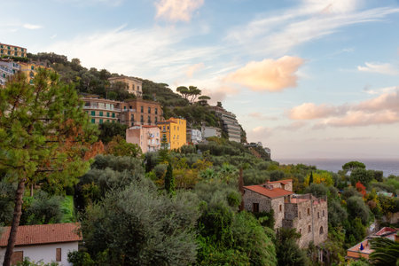 Rocky Coast and Homes in Touristic Town, Sorrento, Italy. Amalfi Coast. Colorful Sunset Skyの写真素材
