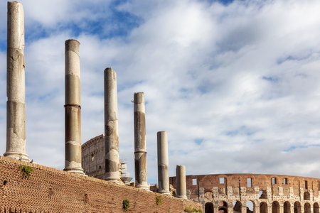 Ancient Remains in Rome, Italy. Colosseum and Central Avenue. Sunny Cloudy Sky.の写真素材