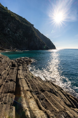 Rocky shore by the sea near touristic town, Riomaggiore, Italy. Cinque Terre National Park. Nature Backgroundの写真素材