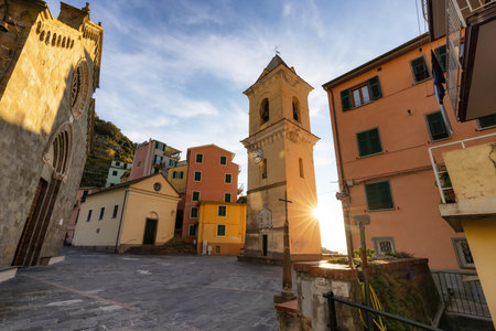 Old Historic Church in touristic town, Manarola, Italy. Cinque Terre National Park. Sunny Sunsetの写真素材