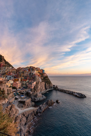 Small touristic town on the coast, Manarola, Italy. Cinque Terre. Colorful Sunny Sunset Fall Season.の写真素材