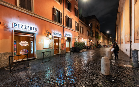 Rome, Italy - November 15, 2022: Old Historic Streets in Downtown. Rainy Night.のeditorial素材