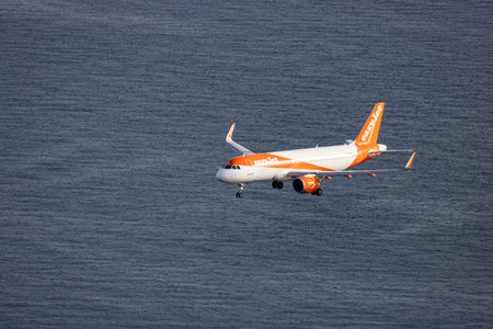 Gibraltar, United Kingdom - October 25, 2022: EasyJet Airplane landing to the airport during sunny morning. Aerial View from Rock of Gibraltar.のeditorial素材