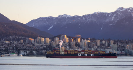 Vancouver, British Columbia, Canada - January 29, 2023: Container Ship in Vancouver Harbour with cityscape in background.のeditorial素材