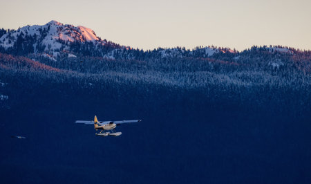 Vancouver, British Columbia, Canada - January 29, 2023: Harbour Air Float Airplane taking off from Vancouver Harbour Airport during winter Sunrise.のeditorial素材