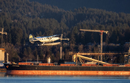 Vancouver, British Columbia, Canada - January 29, 2023: Harbour Air Float Airplane taking off from Vancouver Harbour Airport during winter Sunrise.のeditorial素材