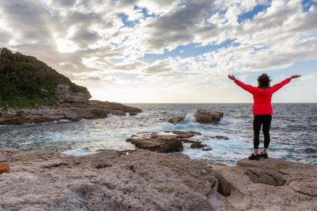 Woman on Rocky Coast in a park at Touristic Town, Sorrento, Italy. Amalfi Coast. Adventure Travelの写真素材