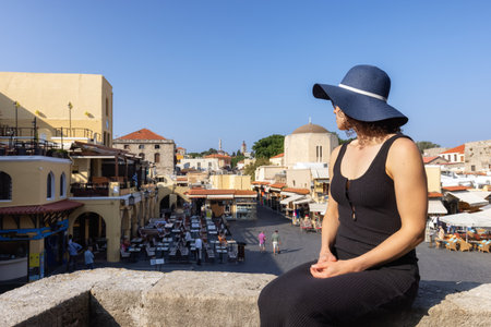 Woman Tourist Traveler at Ruines in the historic Old Town of Rhodes, Greece. Sunny Morning.の写真素材
