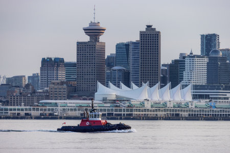 Vancouver, BC, Canada - March 18, 2023: Tug Boat in front of Canada Place and Downtown City.のeditorial素材