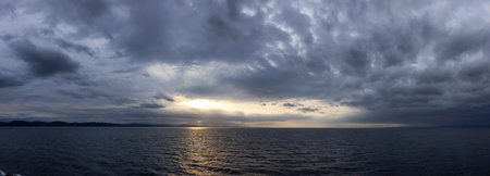 Cloudy Cloudscape during stormy everning on the West Coast of Pacific Ocean. British Columbia, Canada. Sunset Sky. Panoramaの写真素材