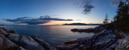 Rocky Shore on West Coast of Pacific Ocean. Lighthouse Park in West Vancouver, British Columbia, Canada. Sunset Sky.の写真素材