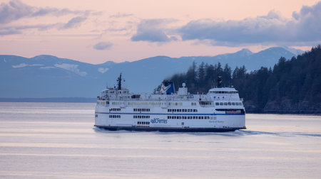 West Vancouver, British Columbia, Canada - April 14, 2023: BC Ferries leaving the Horseshoe Bay Terminal in Howe Sound during colorful Sunset.のeditorial素材