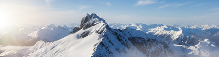 Rugged Canadian Mountain Peak Covered in Snow. Aerial Landscape Sunset. Squamish, British Columbia, Canada.の写真素材