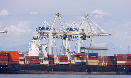 Tsawwassen, BC, Canada - May 19, 2023: Container Ship at the Port being loaded for shipment.のeditorial素材
