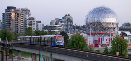 Downtown Vancouver, British Columbia, Canada - May 29, 2023: Skytrain riding by Science World during Sunn Sunset.のeditorial素材
