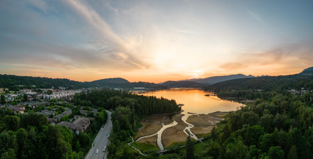 Residential Neighborhood and Park in Suburban City. Port Moody, Vancouver, BC, Canada. Aerial. Sunset Skyの写真素材