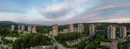 Residential Neighborhood and Apartment Buildings in Suburban City. Port Moody, Vancouver, BC, Canada. Aerial. Sunset Skyの写真素材