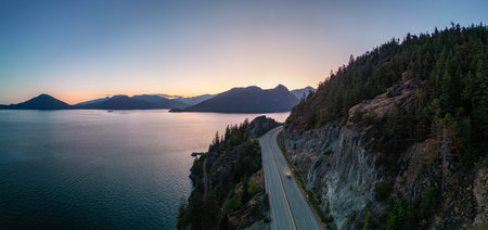 Sea to Sky Highway on Pacific Ocean West Coast. Aerial Panorama. Sunny Colorful Sunset. Located in Howe Sound between Vancouver and Squamish, British Columbia, Canada.の写真素材