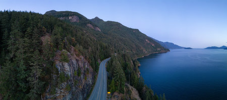 Sea to Sky Highway on Pacific Ocean West Coast. Aerial Panorama. Sunny Colorful Sunset. Located in Howe Sound between Vancouver and Squamish, British Columbia, Canada.の写真素材