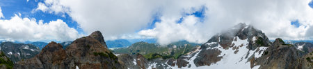Aerial Panoramic View of Rocky Mountain Landscape. Cloudy Sunny Day. Taken in British Columbia, Canada. Nature Backgroundの写真素材