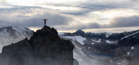Adventurous Woman Standing on top of Mountain Cliff. Extreme Adventure Composite. 3d Rendering Peak. Background Aerial Image from British Columbia, Canada.の写真素材