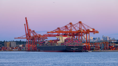 Vancouver, BC, Canada - June 16, 2023: Ship, Containers and Cranes in Port of Vancouver and City in Background.のeditorial素材