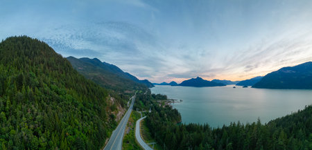 Scenic Highway on the ocean coast with mountain landscape. Sea to Sky Hwy, North of Vancouver, BC, Canada. Aerial view. Sunsetの写真素材