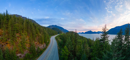 Scenic Highway on the ocean coast with mountain landscape. Sea to Sky Hwy, North of Vancouver, BC, Canada. Aerial view. Sunsetの写真素材