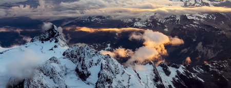 Rocky Mountain Peak covered in clouds. Aerial Landscape Nature Background. View from Airplane, Washington, USA.の写真素材