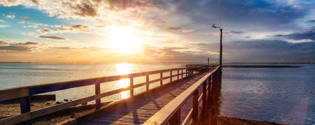 Wooden Quay at Rocky shore on Pacific Ocean West Coast. Sunset. White Rock, Vancouver, BC, Canada.の写真素材