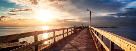 Wooden Quay at Rocky shore on Pacific Ocean West Coast. Sunset. White Rock, Vancouver, BC, Canada.の写真素材