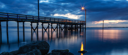 Wooden Quay at Rocky shore on Pacific Ocean West Coast. Sunset. White Rock, Vancouver, BC, Canada.の写真素材
