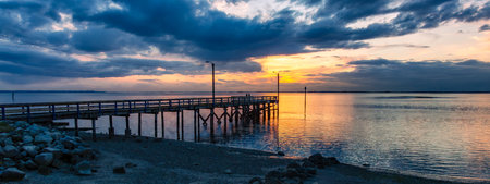 Wooden Quay at Rocky shore on Pacific Ocean West Coast. Sunset. White Rock, Vancouver, BC, Canada.の写真素材