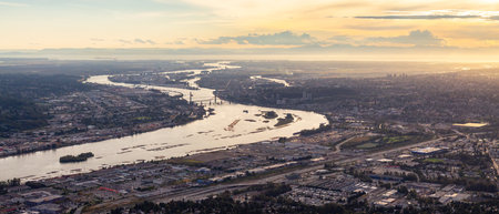 Aerial View of Fraser River and City. Cloudy Sunset Sky. Panorama. New Westminster, Vancouver, BC, Canada.の写真素材