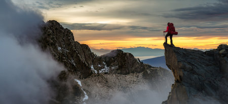Adventurous Woman Standing on top of Mountain Cliff. Extreme Adventure Composite. 3d Rendering Peak. Background Aerial Image from British Columbia, Canada.の写真素材