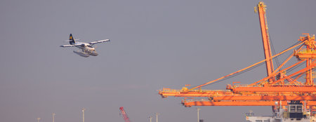 Downtown Vancouver, BC, Canada - September 20, 2023: Seaplane landing in Coal Harbour.