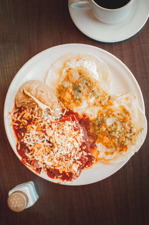Chilaquiles in red sauce with egg and beans, Mexican breakfast
