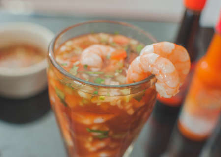 seafood, shrimp cocktail with avocado and vegetables in a glassの写真素材