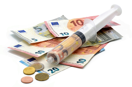 financial syringe on many euros white backgroundの写真素材