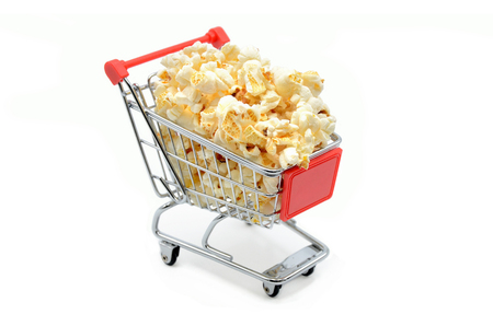 shopping cart with popcorn on a white backgroundの写真素材