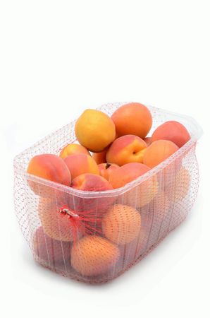 apricots in the packaging on white backgroundの写真素材