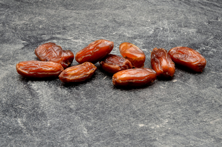 Dates fruit on black background close up photoの写真素材