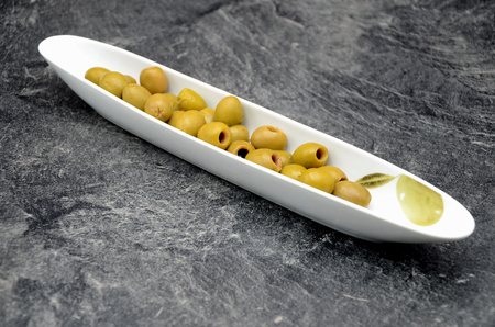 Olives on black background close up photoの写真素材