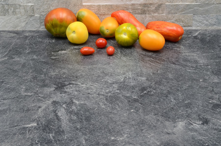 Many Tomatos on a stone background photoの写真素材