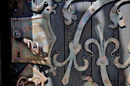 old wood door with metal things and metal door handleの写真素材